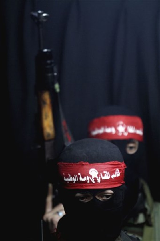 Masked Palestinian militants from the Democratic Front for the Liberation of Palestine hold their weapons in Gaza City on Jan. 8. One Israeli soldier was killed in a firefight late Friday along the Gaza border after soldiers spotted armed Palestinians militants planting explosives along the frontier, a spokesman for the Israeli military said. He said an initial inquiry shows the soldiers were likely wounded by friendly fire when a mortar shell missed the militants and hit the soldiers instead. A military investigation is being opened into the incident, he said. 